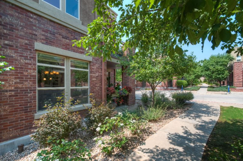 Brick home with landscaped walkway and garden in a quiet Utah neighborhood.