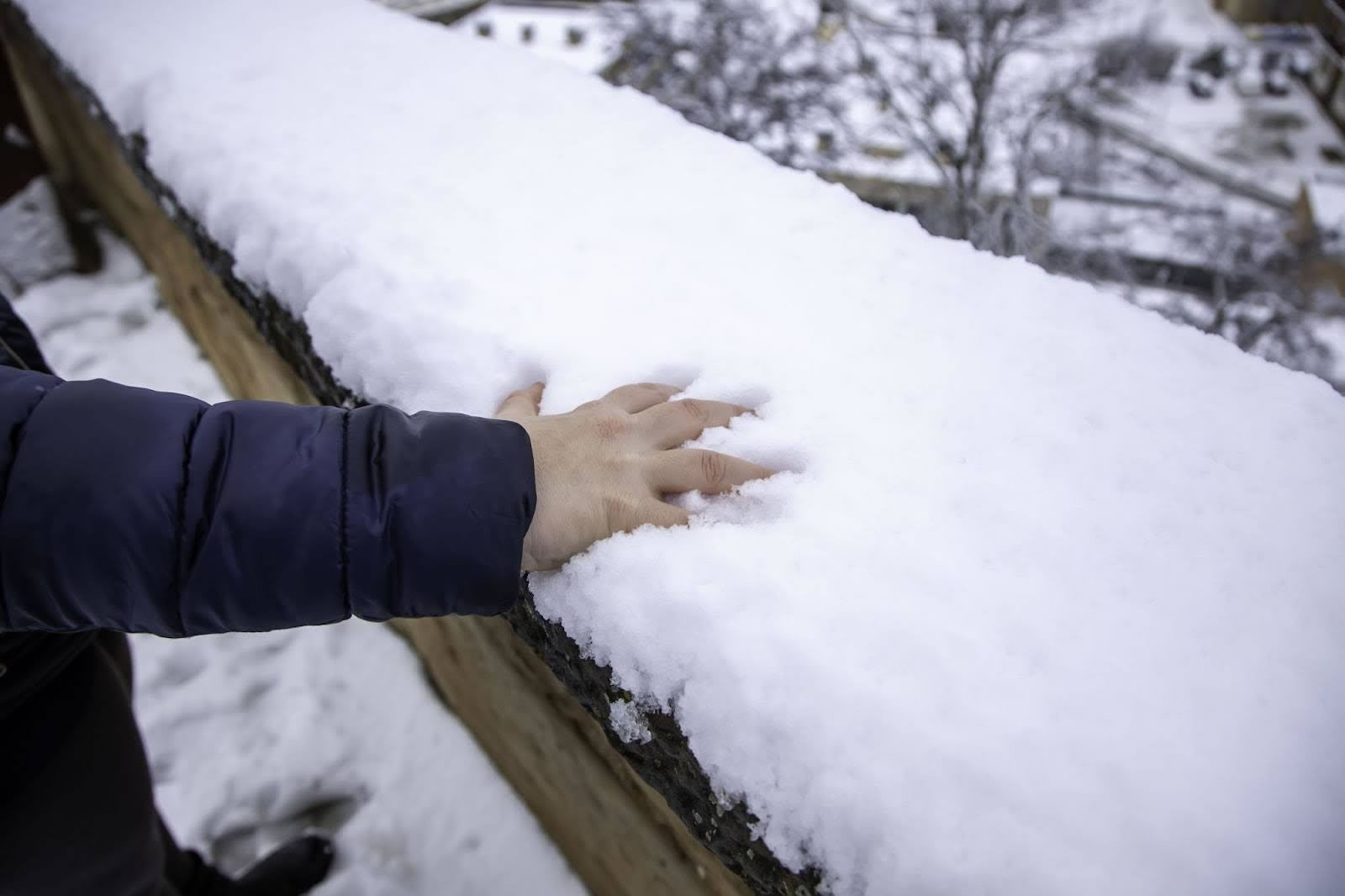 Roofing contractor inspecting roof damage and planning repairs after winter season
